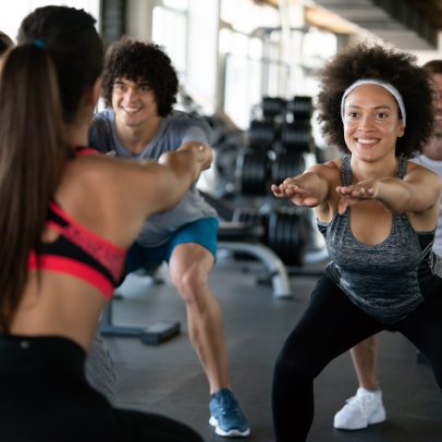 Group of fit young people at the gym exercising